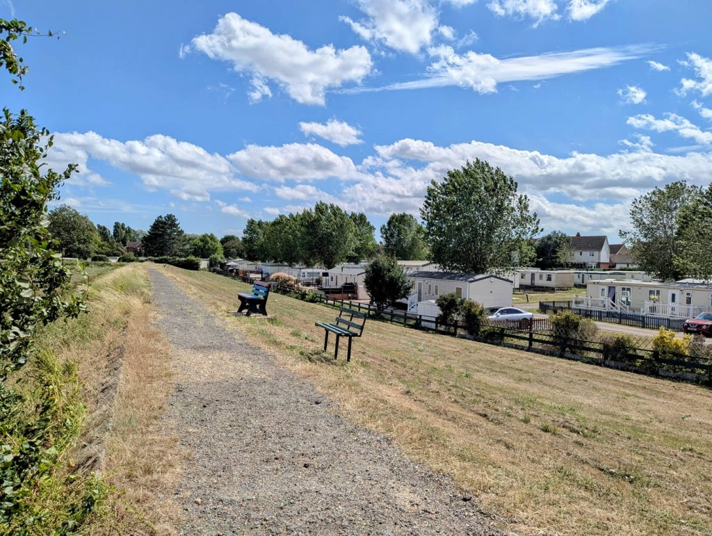 St Lawrence Holiday Park - Park View with benches on coast